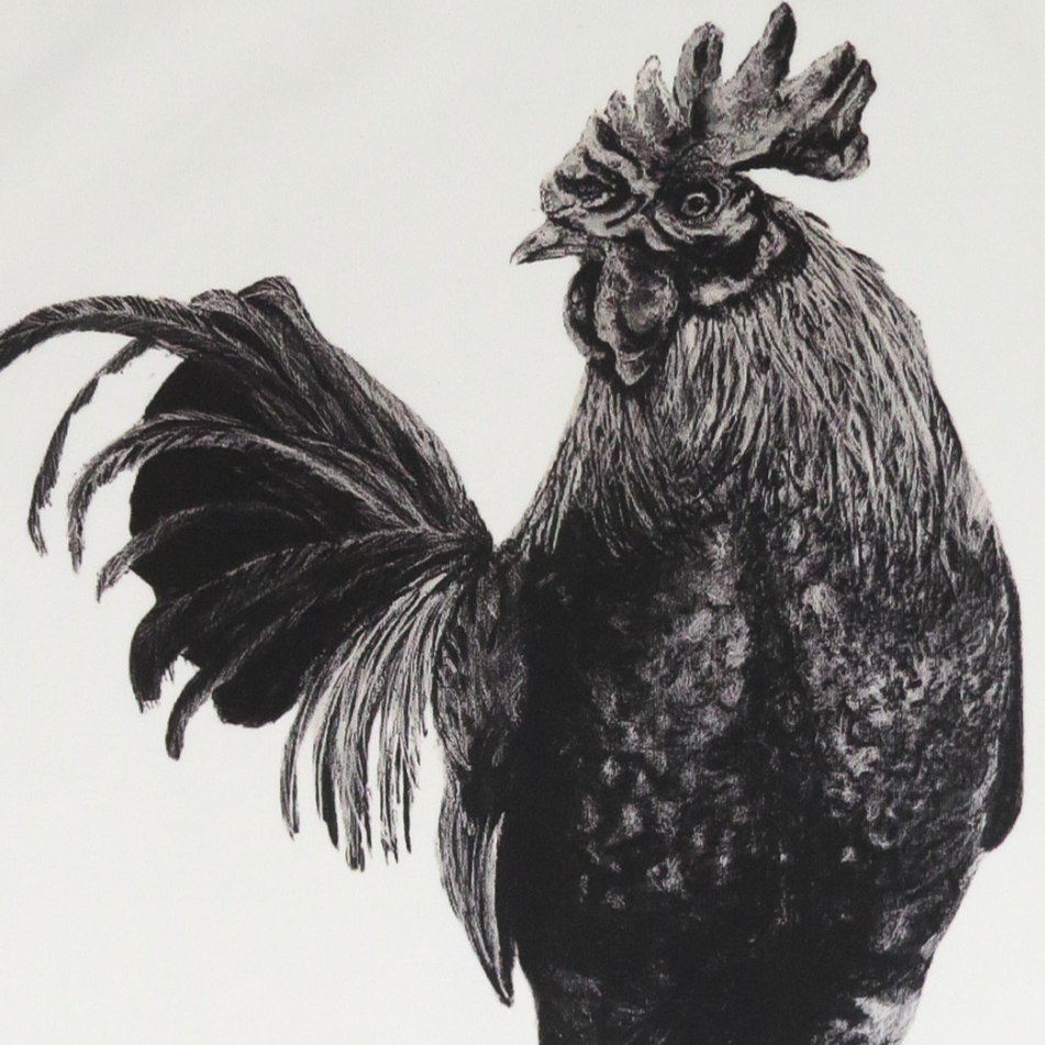 Tea towel with a black and white rooster design on a white background