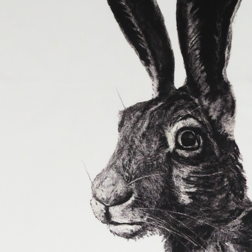 Tea towel with a black and white rabbit illustration on a white background